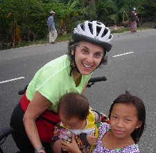 Barbara Levitov biking along fishing villages meeting children