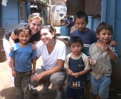 Allisa Whitman (left) and her sister Rachel Whitman surrounded by boys living in El Salvador.